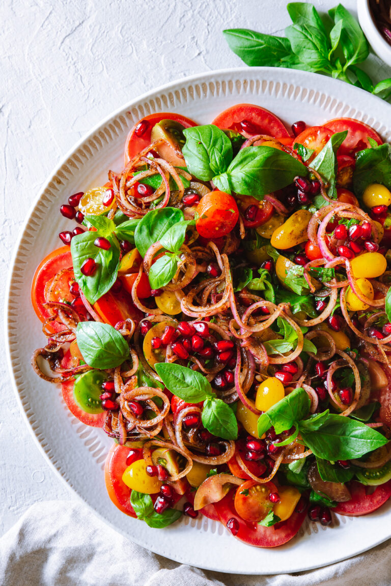 Tomato and pomegranate salad with black lime onions.