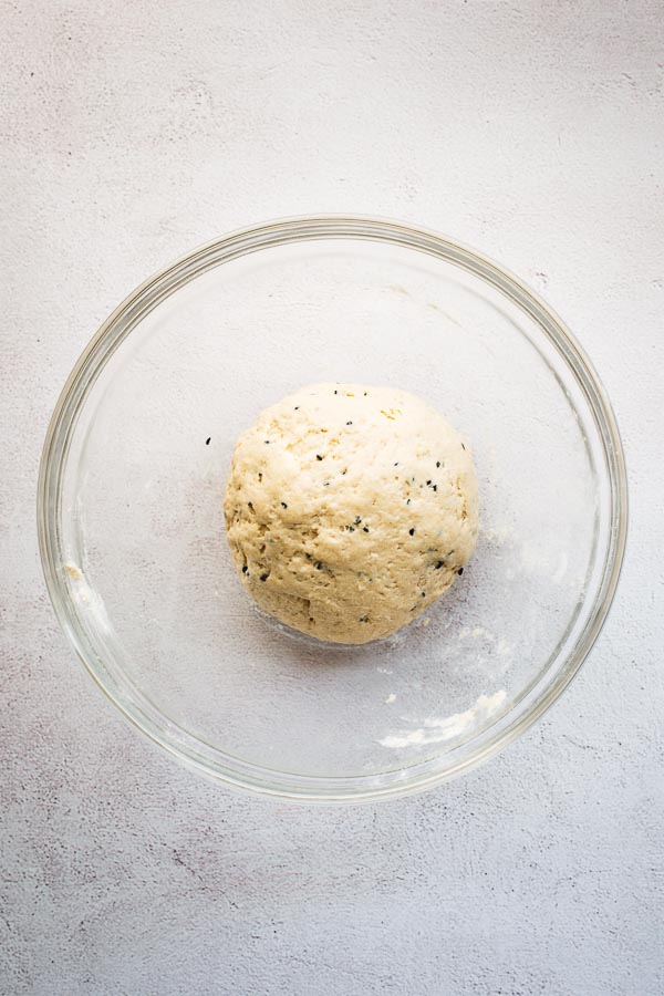 Yoghurt flatbread dough ball in a glass bowl.