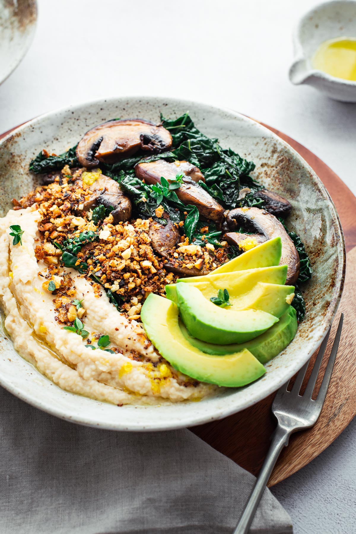 Butter bean mash, crumbs, sautéed mushrooms and kale with sliced avocado.