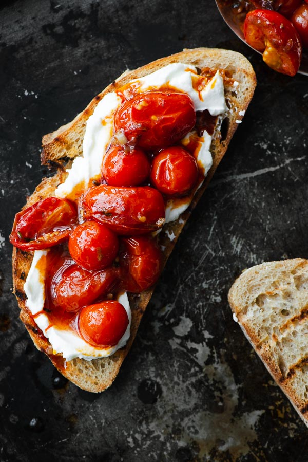 Sourdough toast with labneh and harissa roasted tomatoes.
