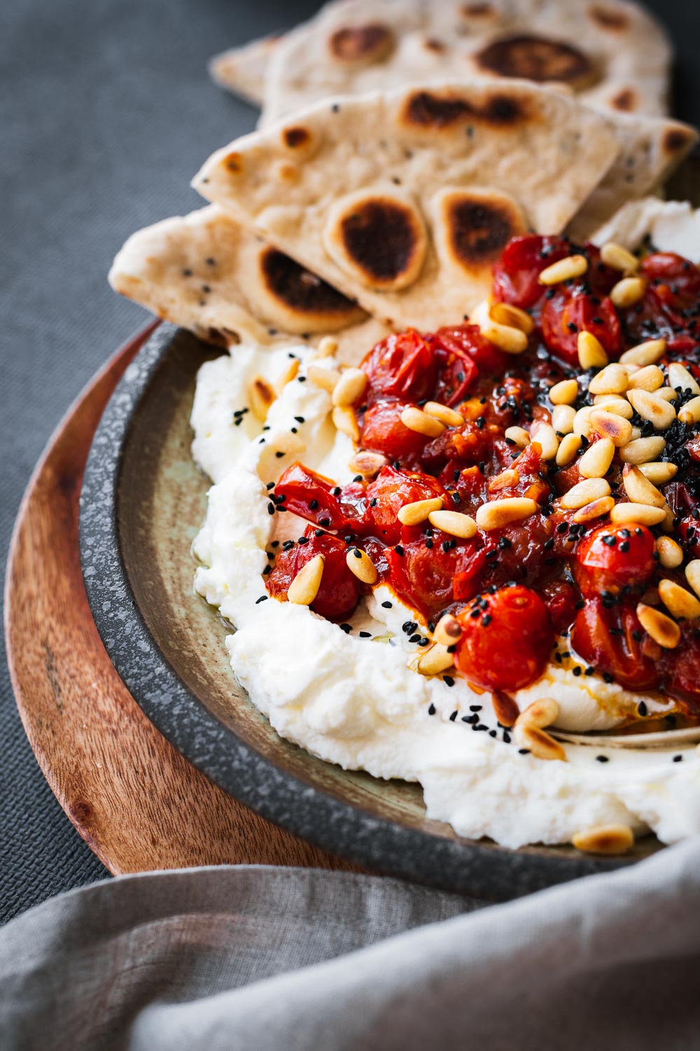 Sweet and spicy tomato sauce on homemade labneh with flatbreads.