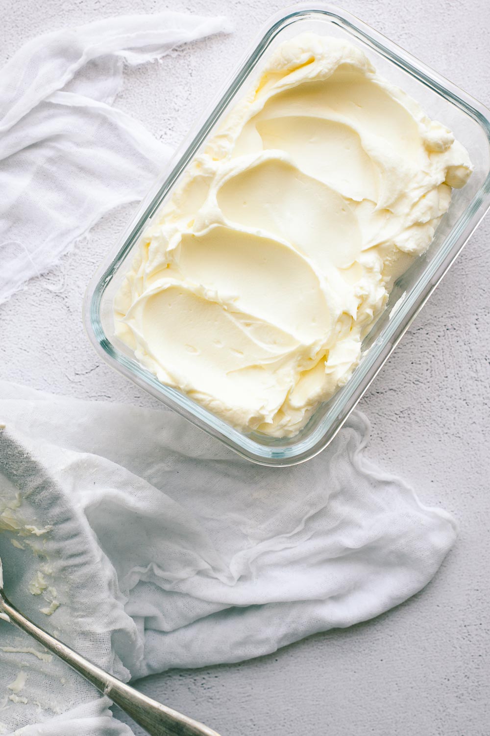 Labneh in a glass container ready to be stored.