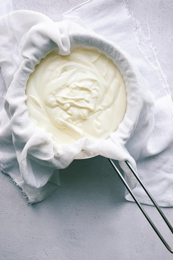 Yoghurt in a muslin-lined sieve.