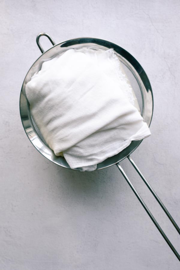 Yoghurt wrapped in muslin ready to be strained.