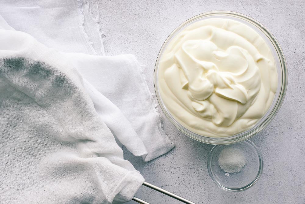 Yoghurt and salt in bowls, ready to be mixed and strained for labneh.