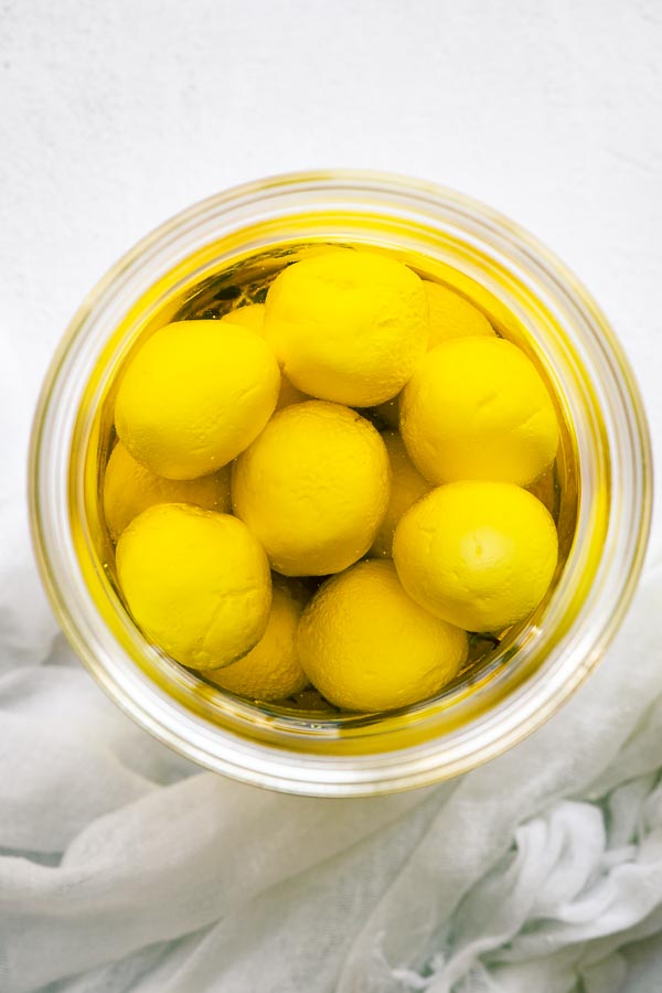 Top down view of labneh balls in olive oil.