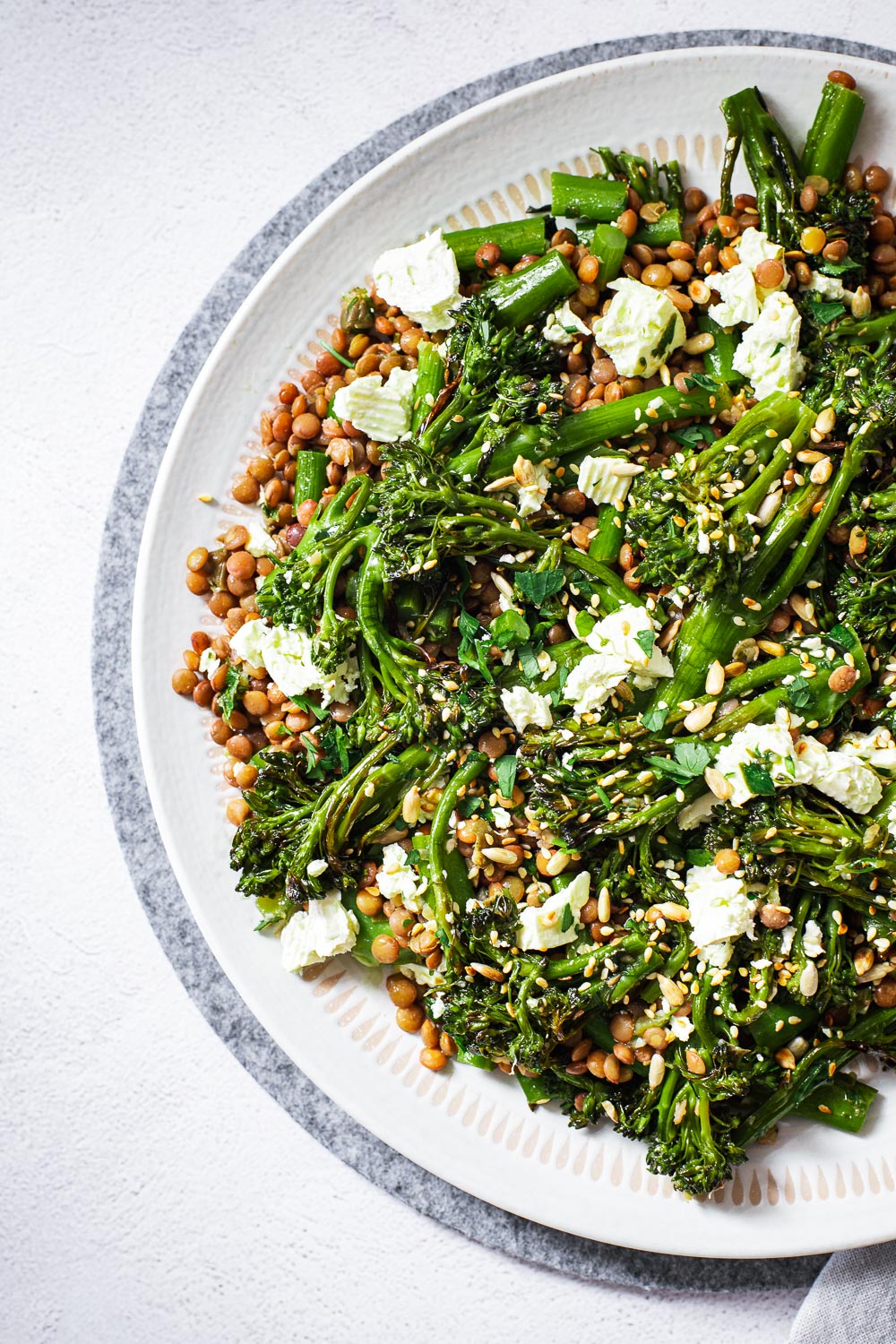 Charred broccolini and lentil salad with preserved lemon and caper dressing.