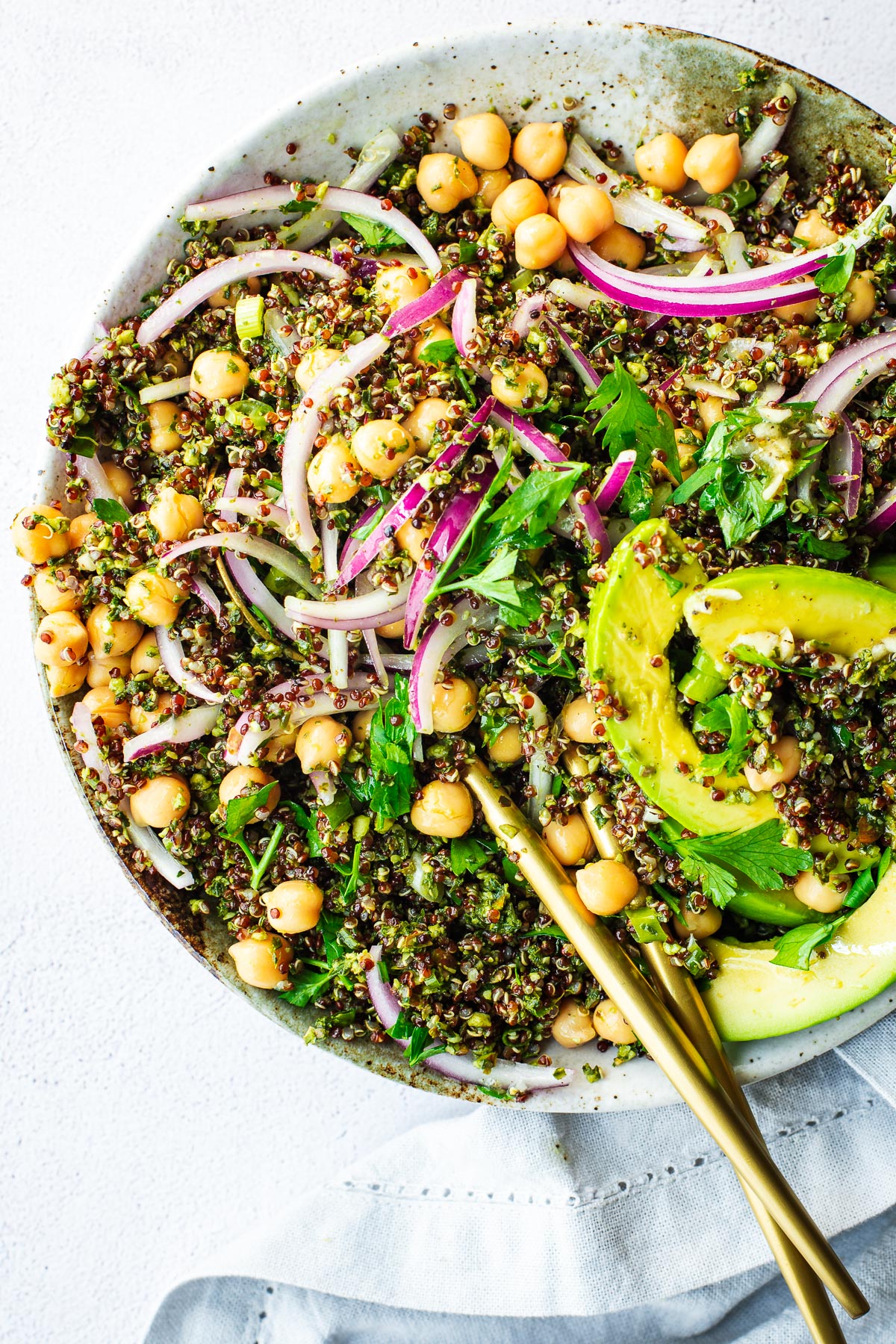 Close-up of kale quinoa salad with chickpeas and avocado and a preserved lemon dressing.