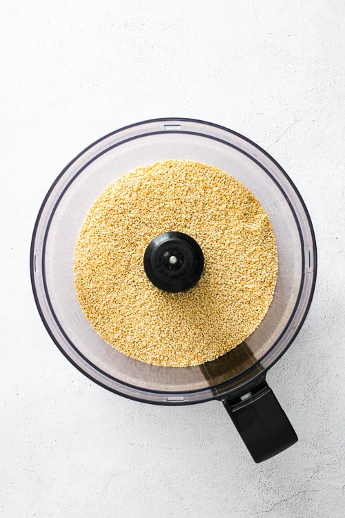 Sesame seeds in the bowl of a food processor.