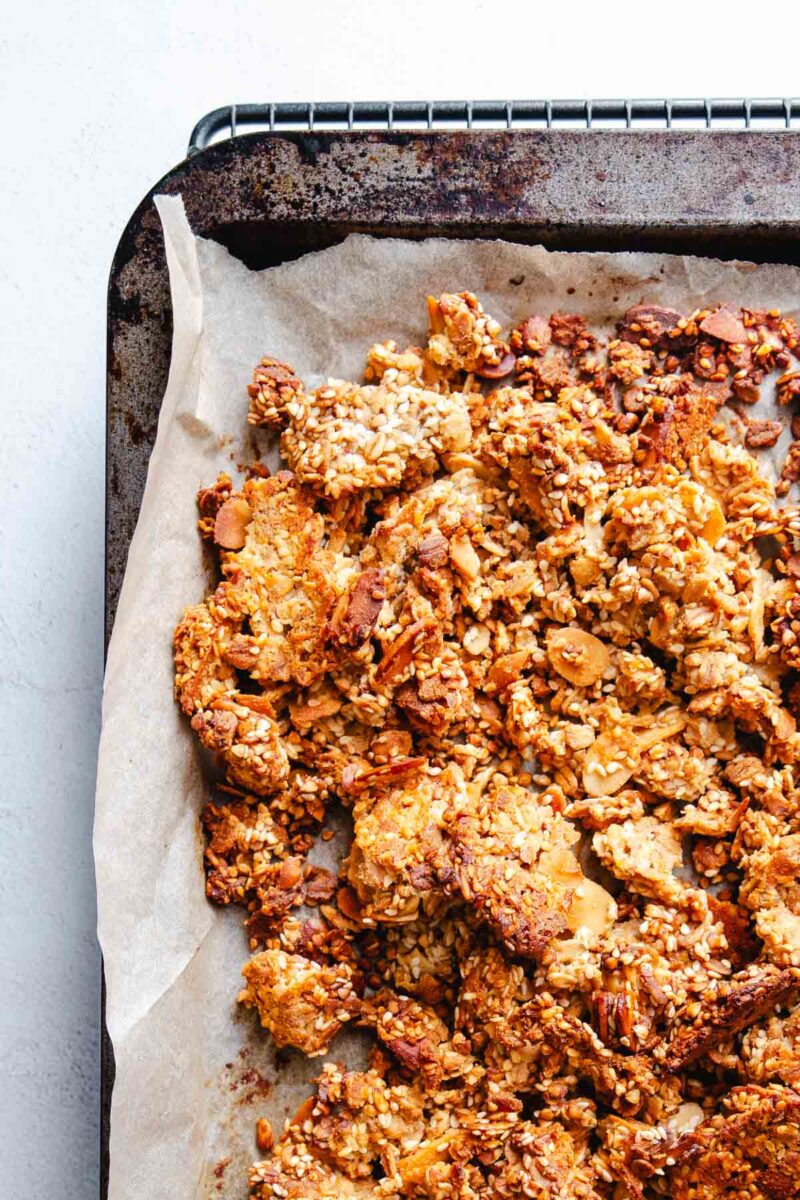 Wholesome granola baked on parchment paper.