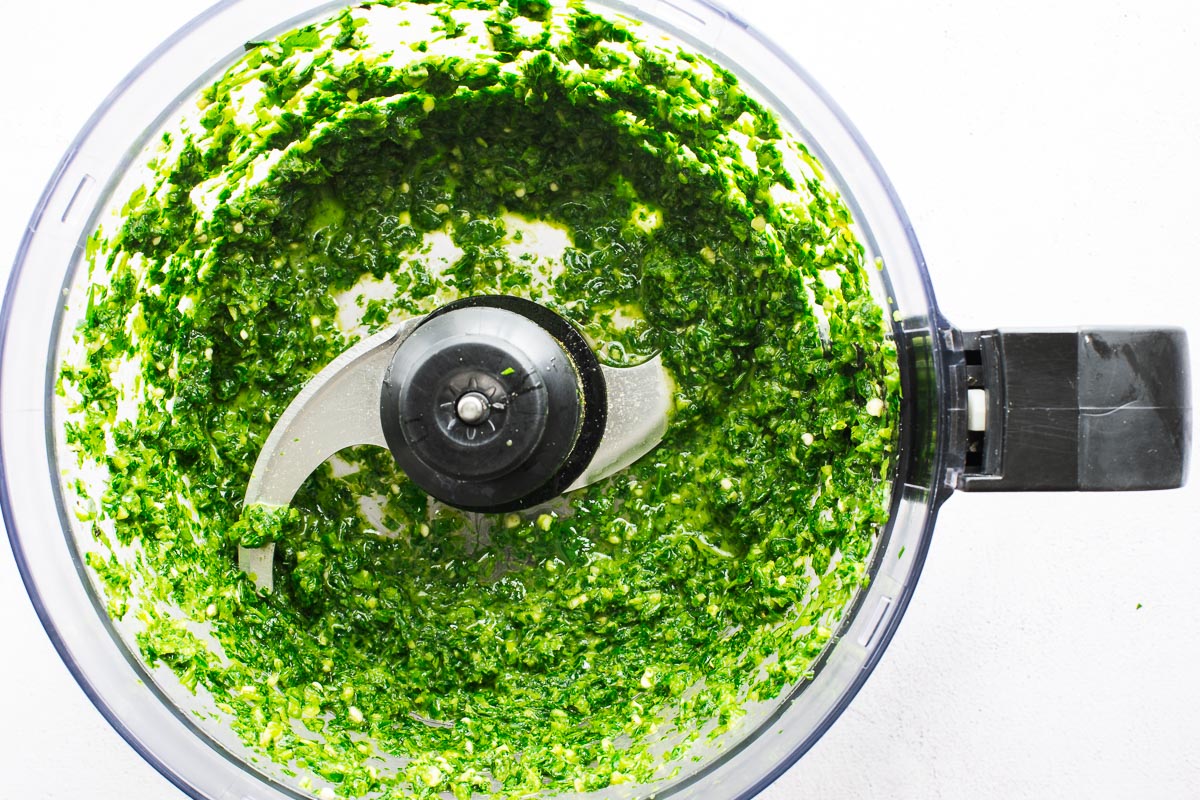 Zhug sauce in a food processor, viewed from above.