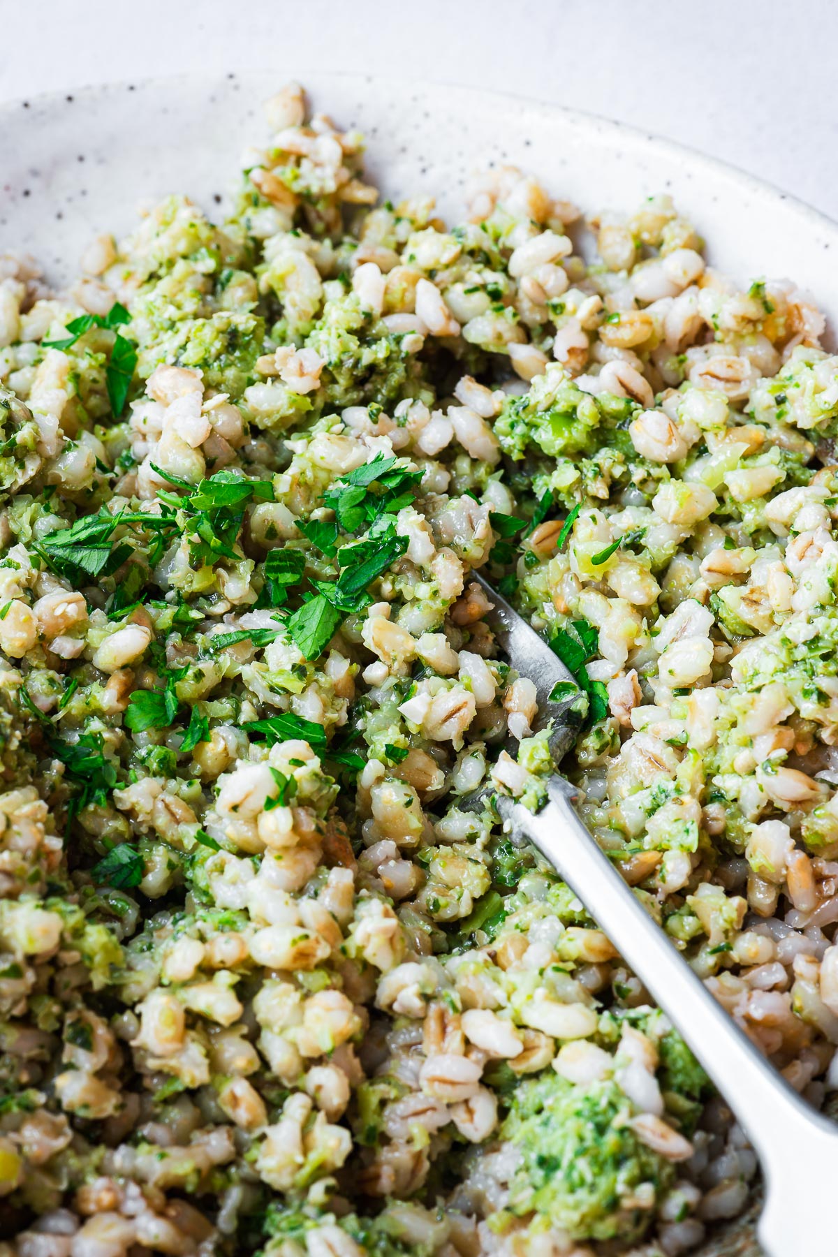 Close-up of cooked barley with pesto.