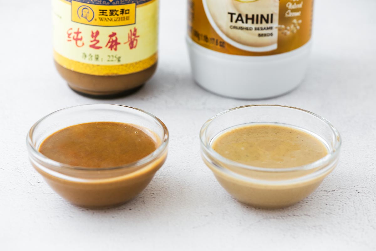 Chinese sesame paste and tahini in small glass bowls for comparison. The sesame paste is a darker colour compared to the blonde tahini paste.