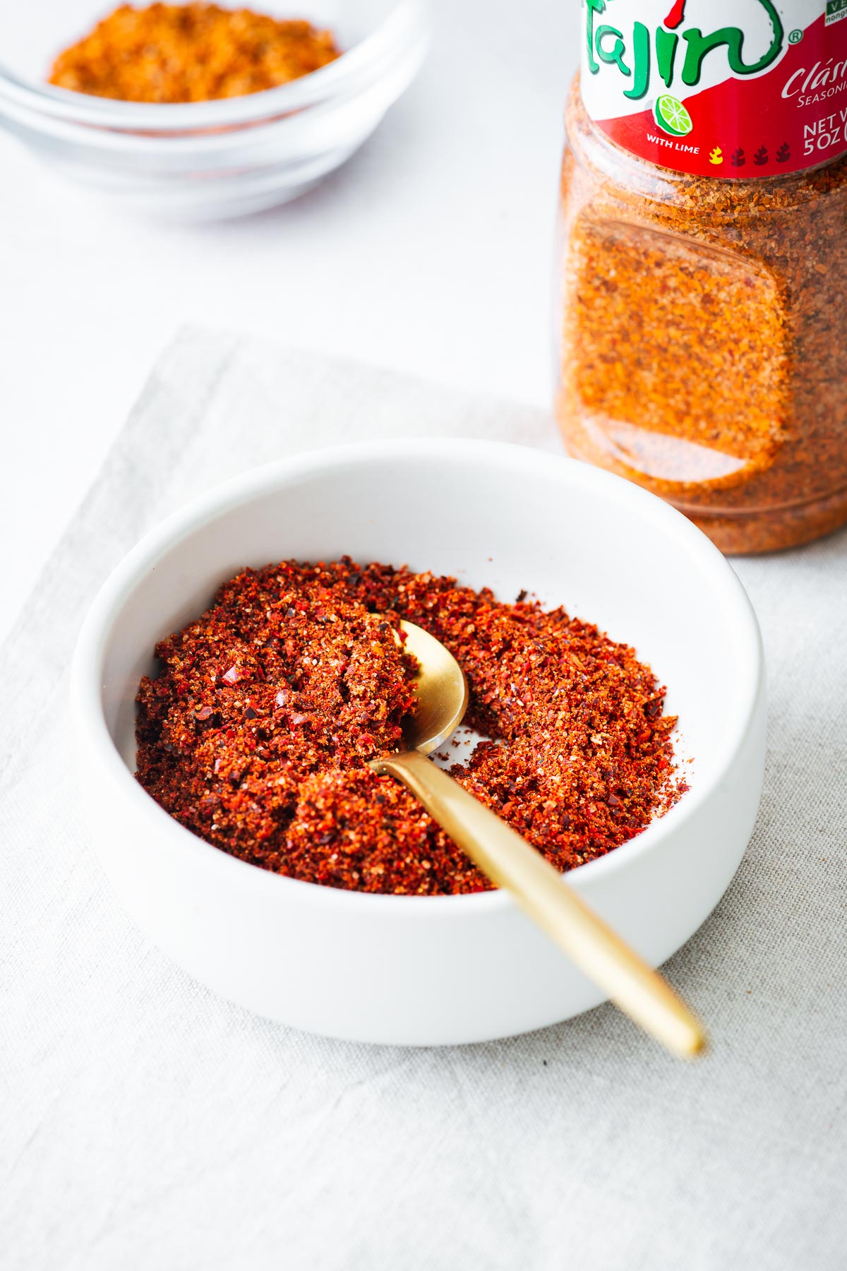 Close-up of a homemade tajin seasoning substitute with a bottle of Tajín Clásico Seasoning in the background.