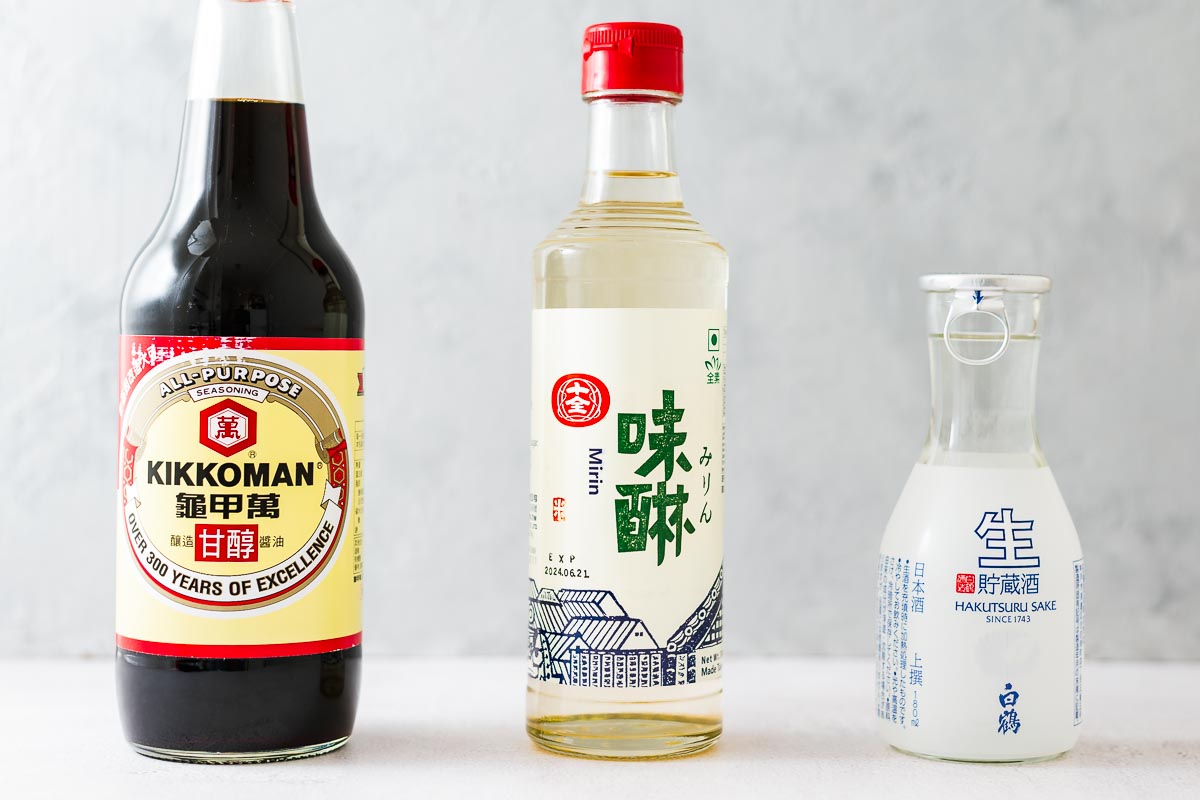 Bottled sukiyaki sauce ingredients including soy sauce, mirin and sake.