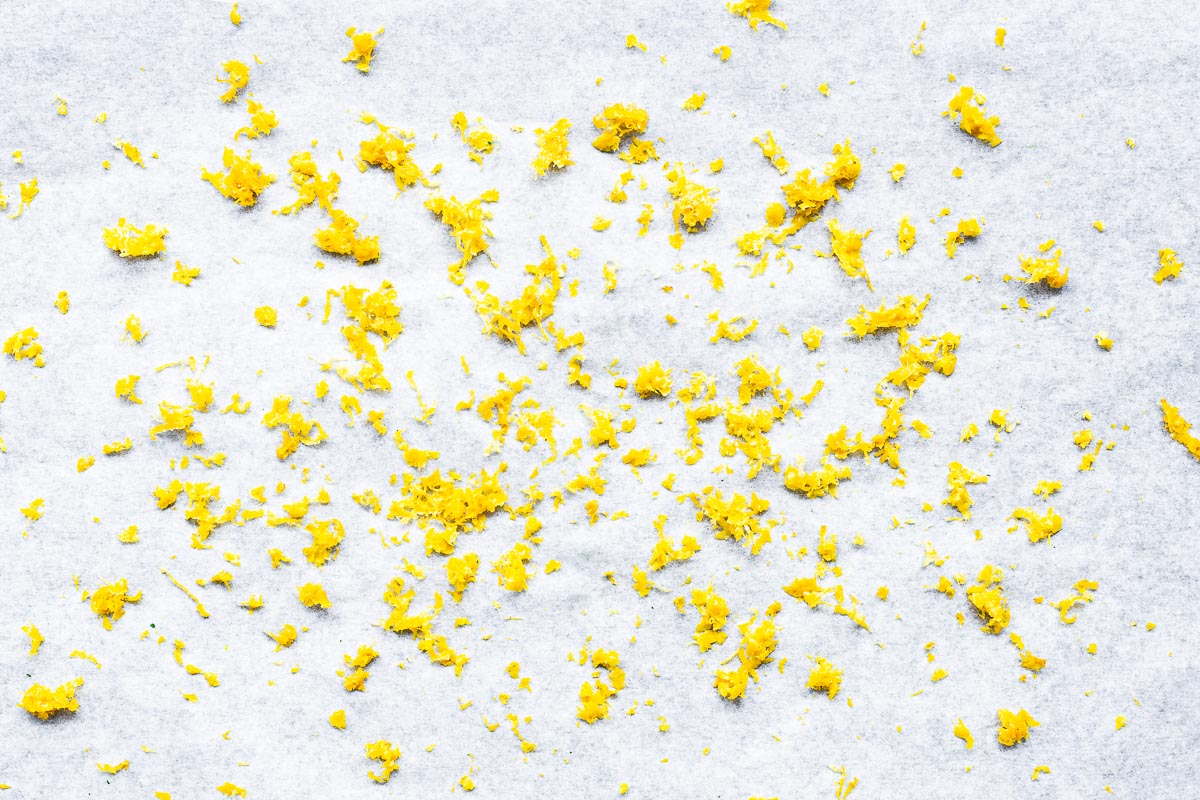 Lemon zest on parchment paper viewed from above.