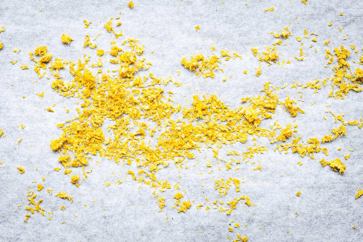 Oven-dried lemon zest on baking paper viewed from above.