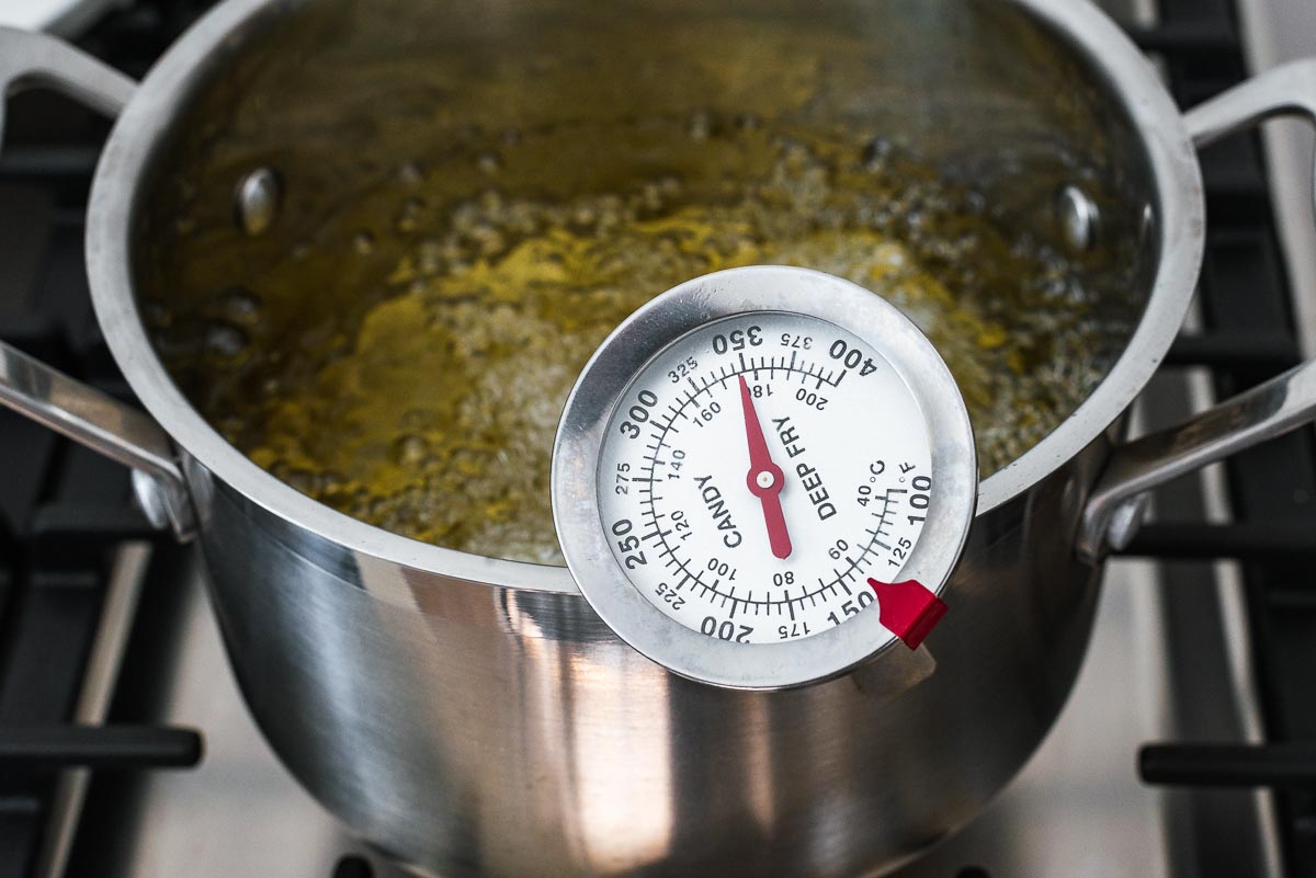 A pot with cooking oil and a thermometer that reads 350 °F.