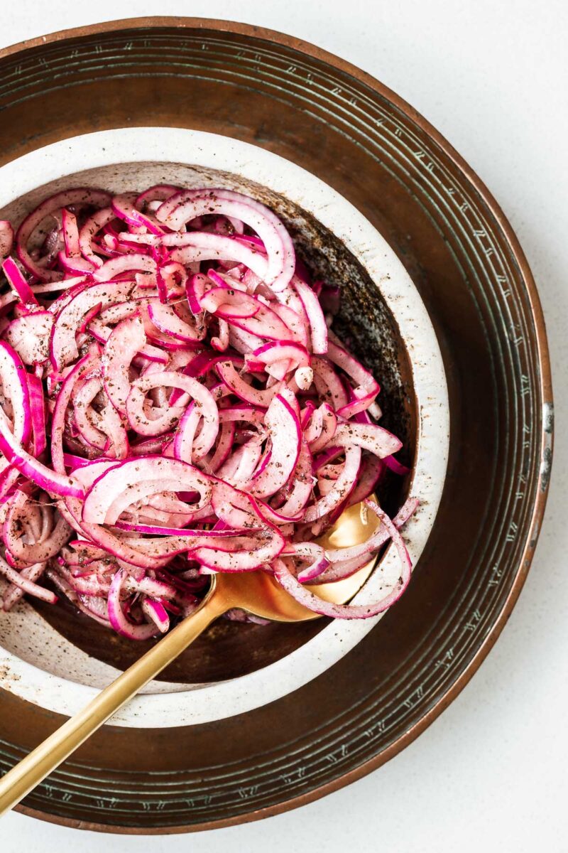 Top down view of a raw onion salad with sumac marinade.