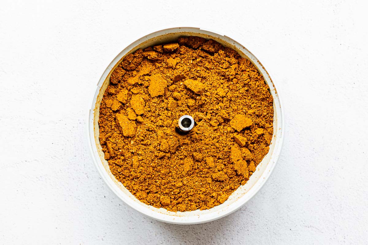 Ground homemade Madras curry powder in a spice grinder.