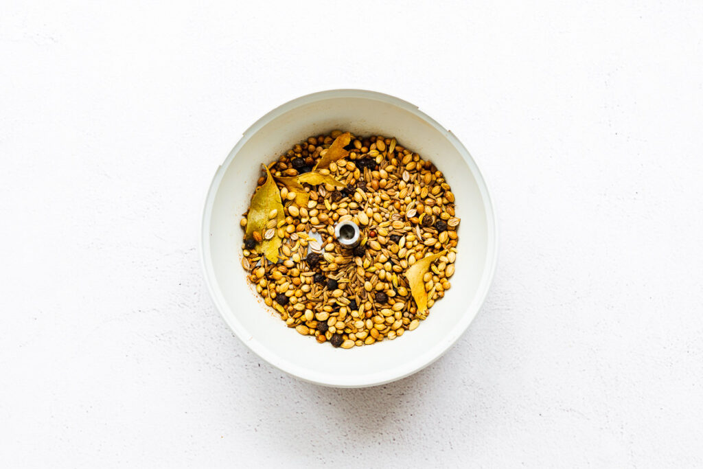 Toasted curry powder spices in a spice grinder bowl.