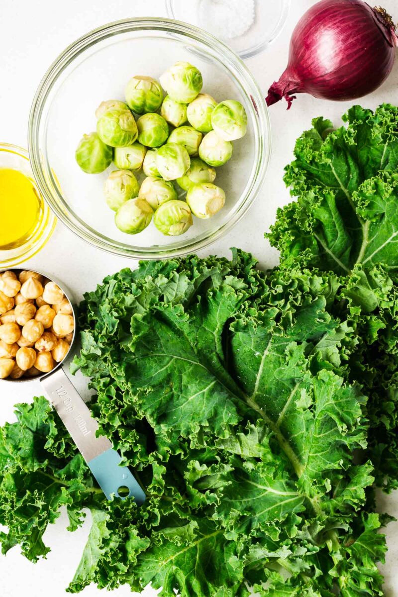 Kale salad ingredients arranged on a kitchen counter.