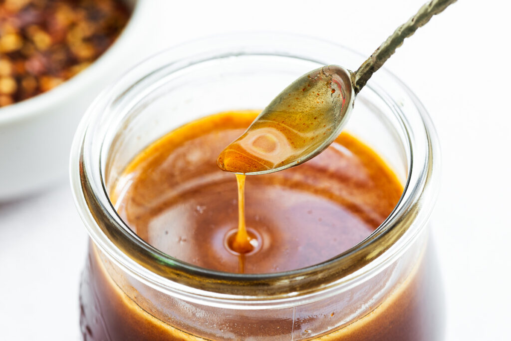 A small spoon of hot honey sauce.
