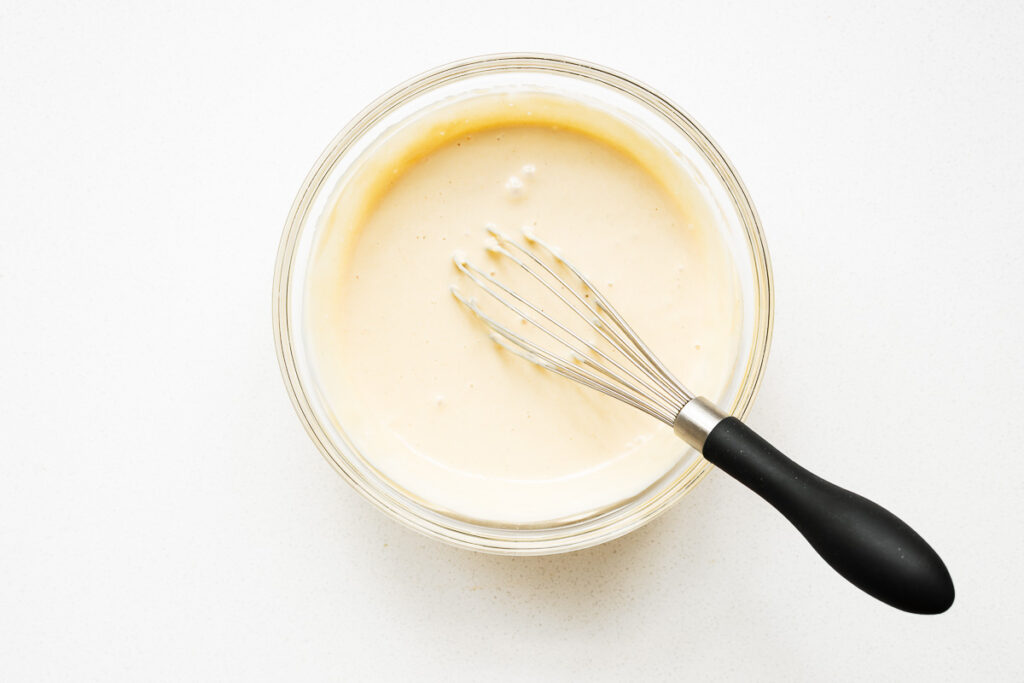 The plant-based maple tahini dressing is whisked until ultra-creamy, light and airy.