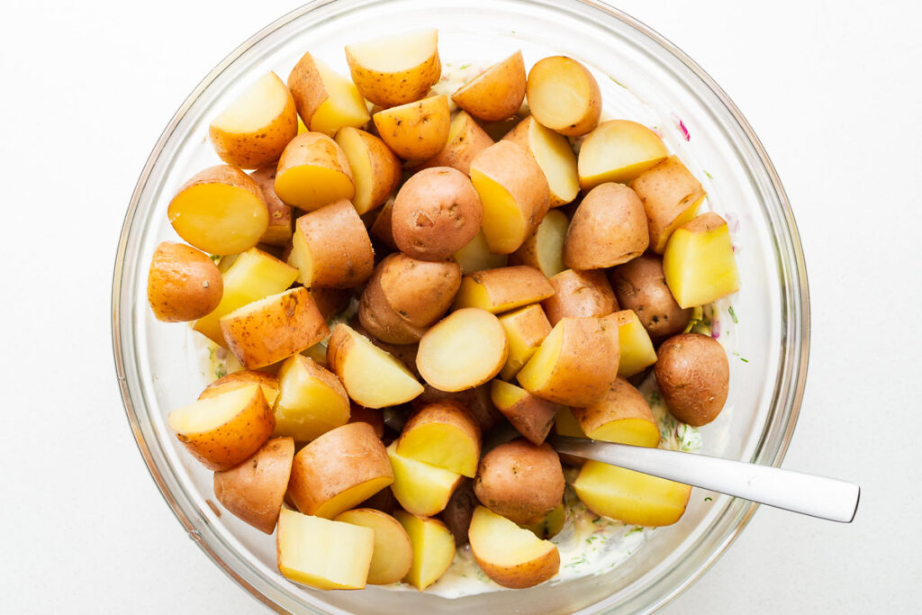 Cooked red potatoes in a large bowl.