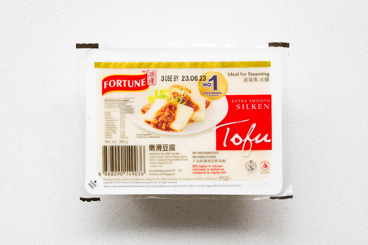 Fortune brand extra smooth silken tofu in plastic packaging viewed from above.