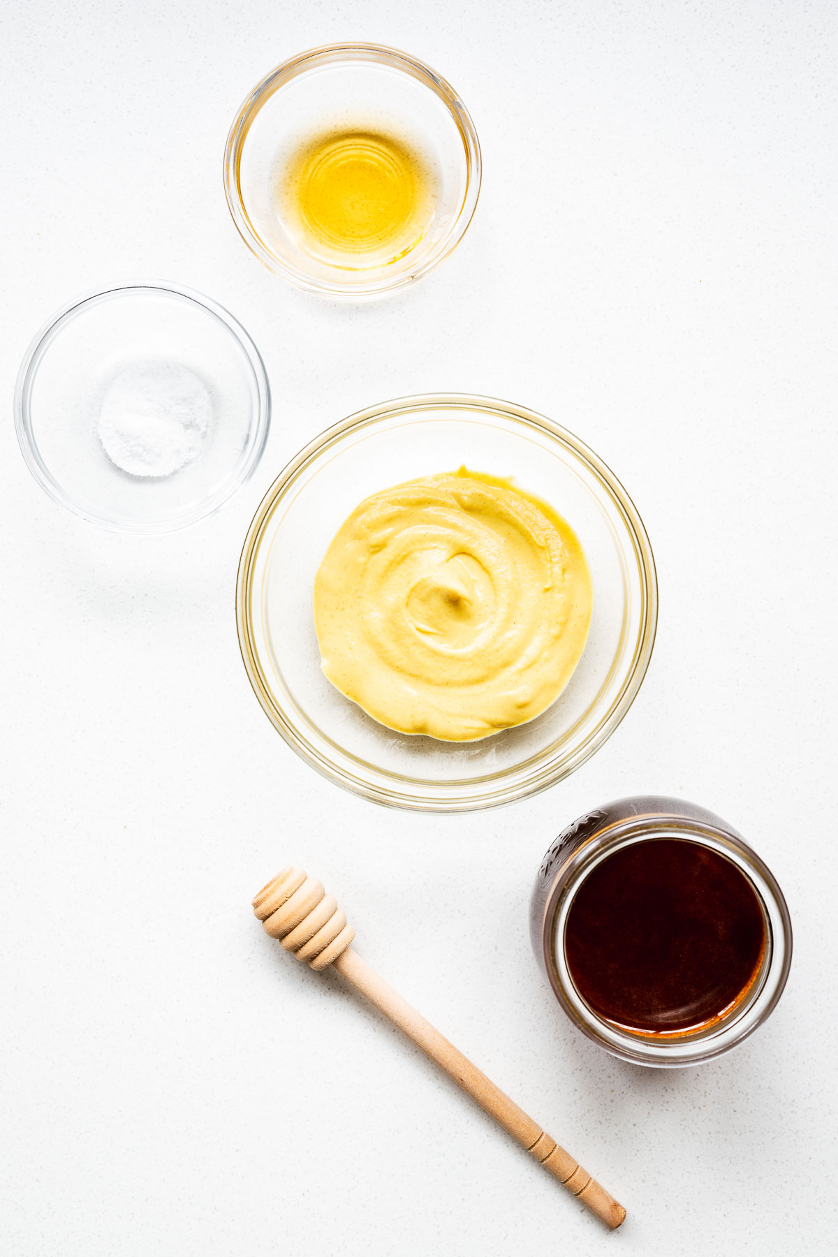 Hot honey mustard sauce ingredients arranged on a kitchen counter.