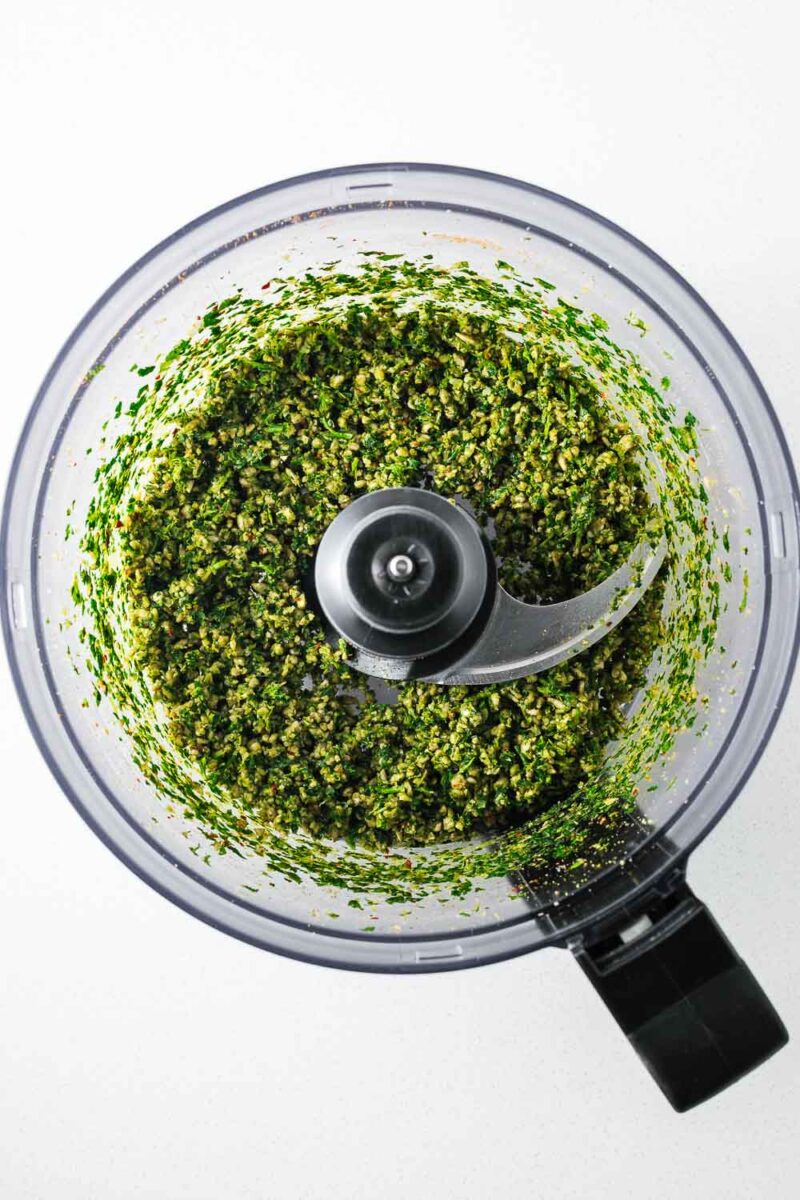Coarsely blended sunflower seeds and herbs in a food processor.