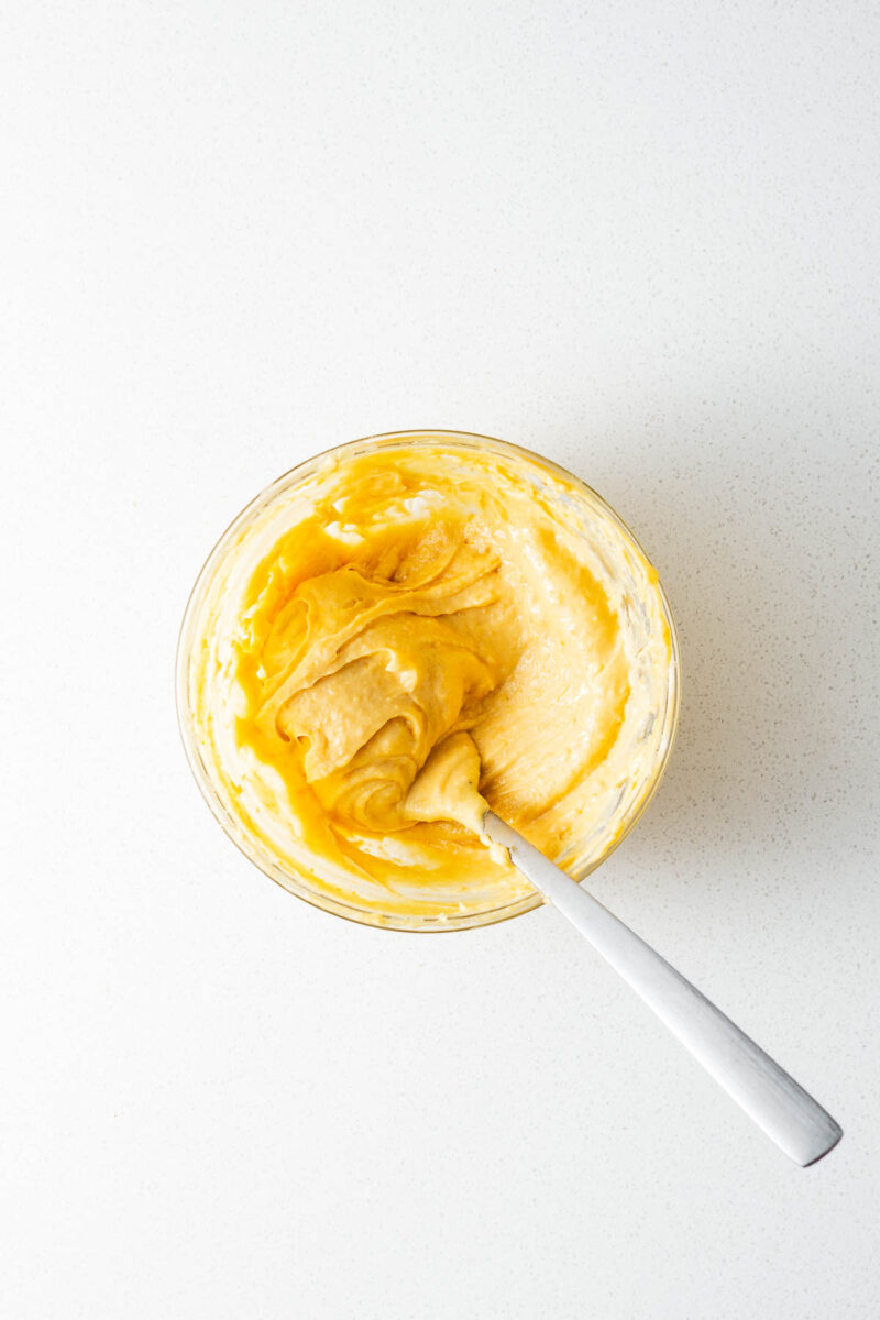 A small glass mixing bowl with a fork mixing homemade miso butter.