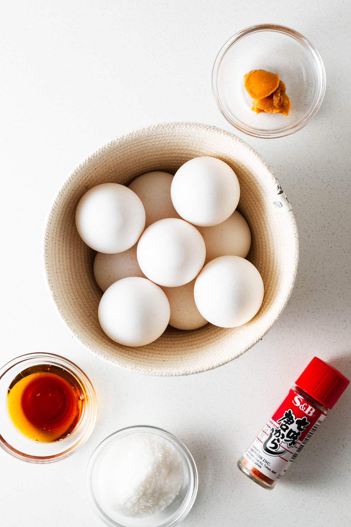 Ingredients for miso eggs arranged on a kitchen counter viewed from above.