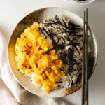 Miso scrambled eggs on rice with shredded nori and Japanese seven-spice.