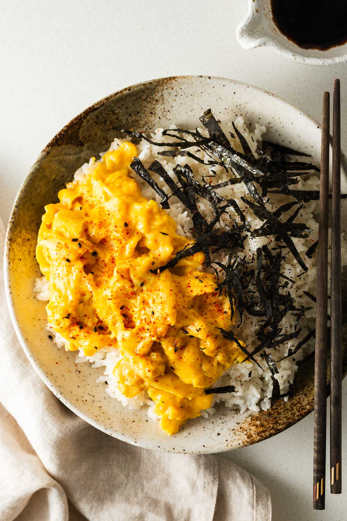 Japanese scrambled miso eggs and rice with shredded nori and Japanese seven-spice.