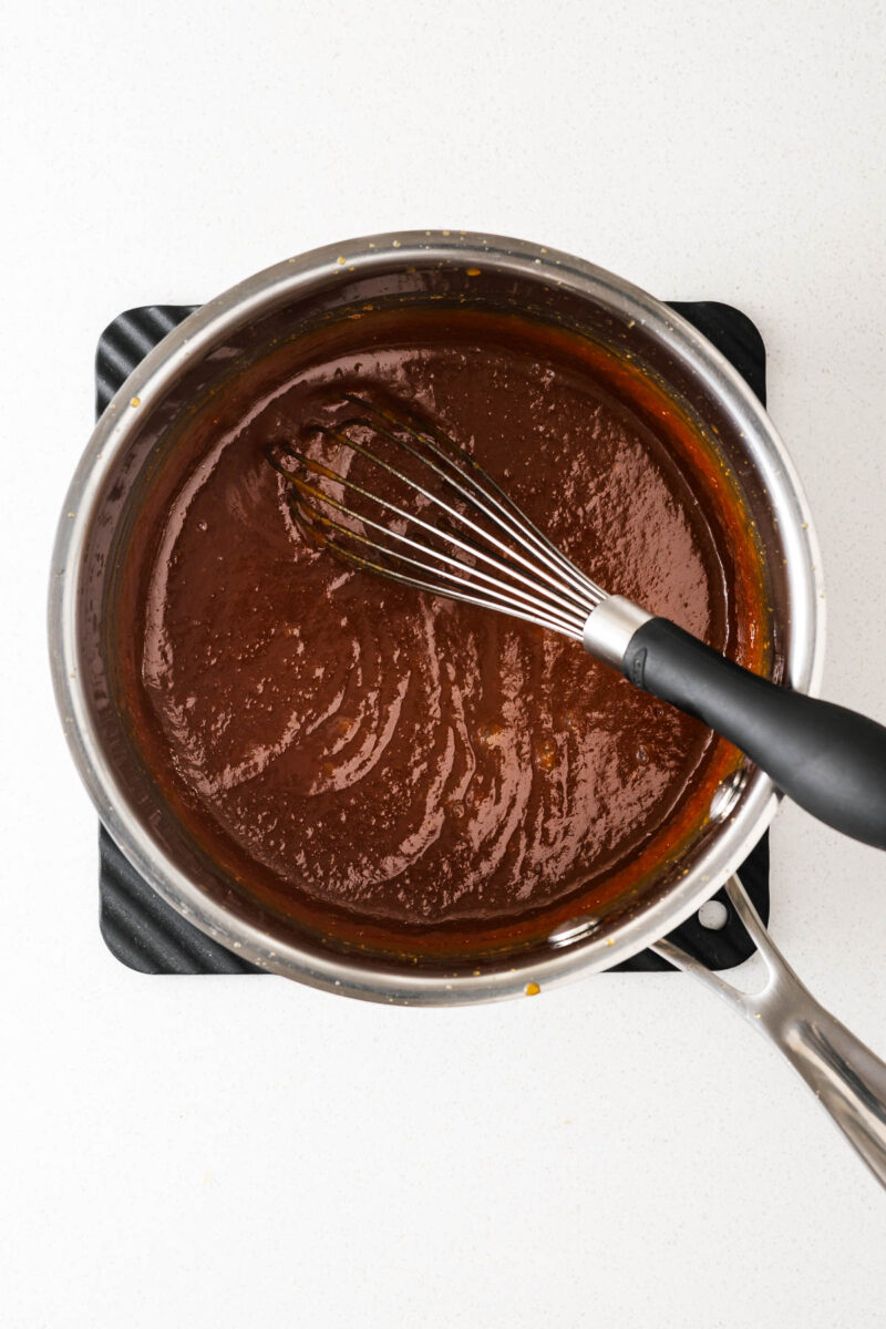 Sweet miso sauce cooked until thick and glossy in a saucepan viewed from above.