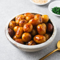 Korean potato side dish of soy-braised potatoes in a small ceramic bowl.