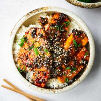 A rice bowl with extra-firm tofu pan-fried and braised in a spicy gochujang sauce.