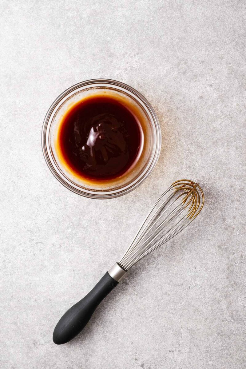 Three-ingredient okonomiyaki sauce whisked together in a small glass bowl.