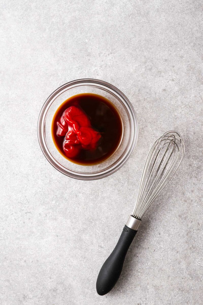 Tomato ketchup, Worcestershire sauce and sweet soy sauce in a small bowl.
