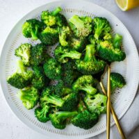 Vibrant green Instant Pot steamed broccoli on a serving plate.