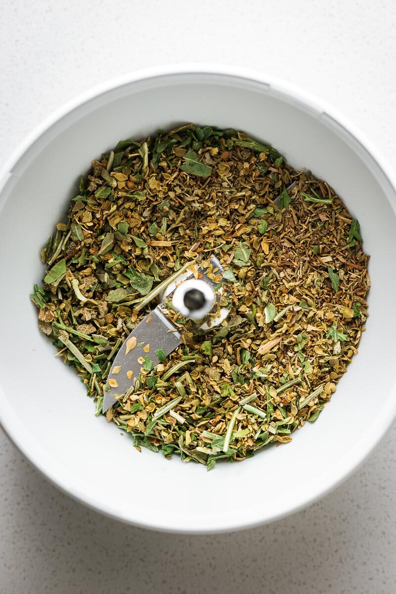 Homemade Italian seasoning substitute in a small food processor viewed from above.