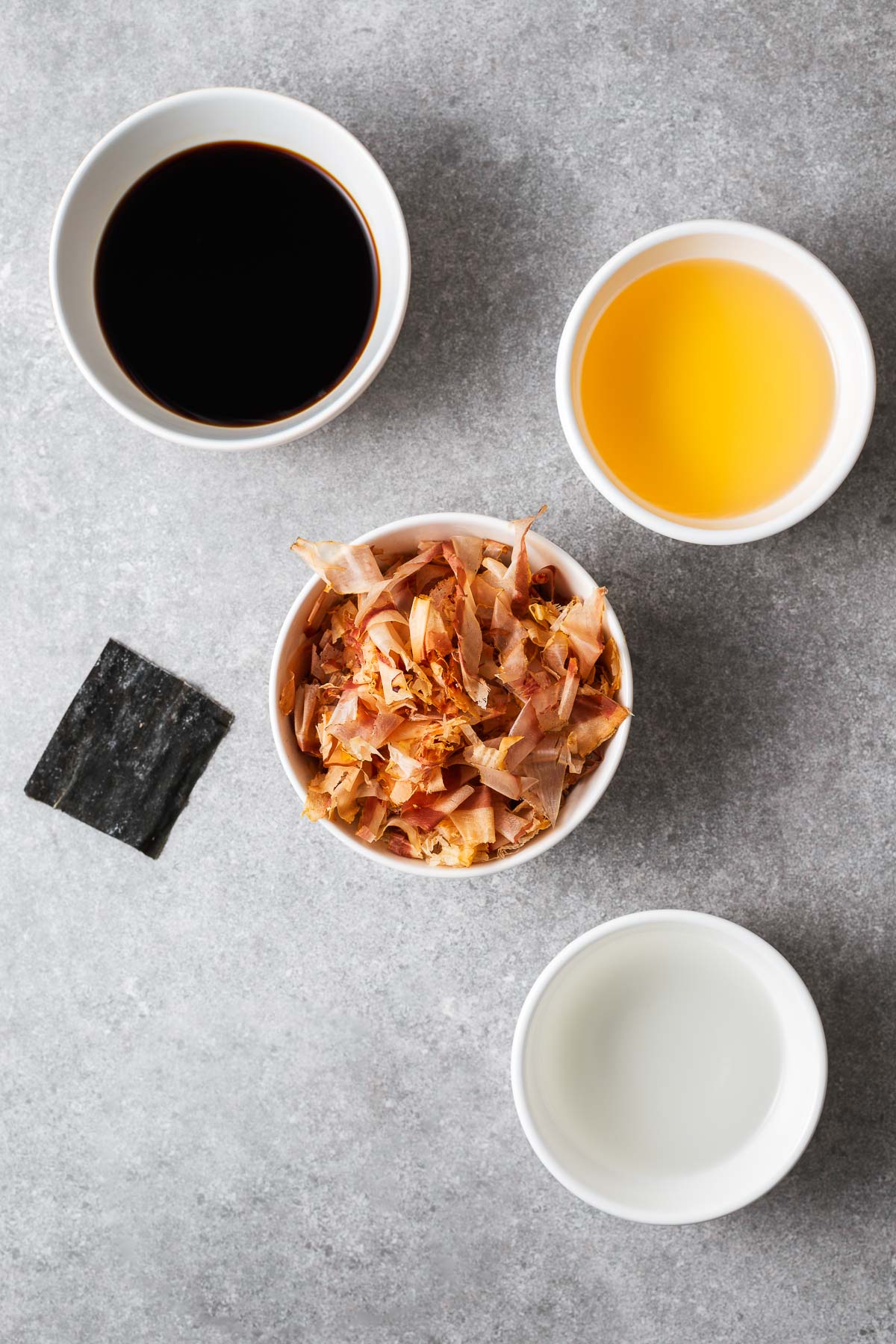 Ingredients for mentsuyu include bonito flakes (katsuobushi), kombu (dried kelp), mirin and sake.