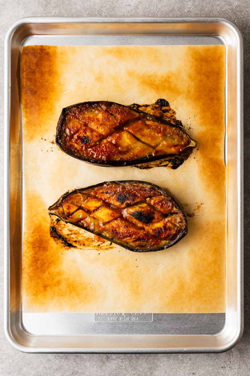 Broiled (grilled) miso eggplant on a baking sheet.