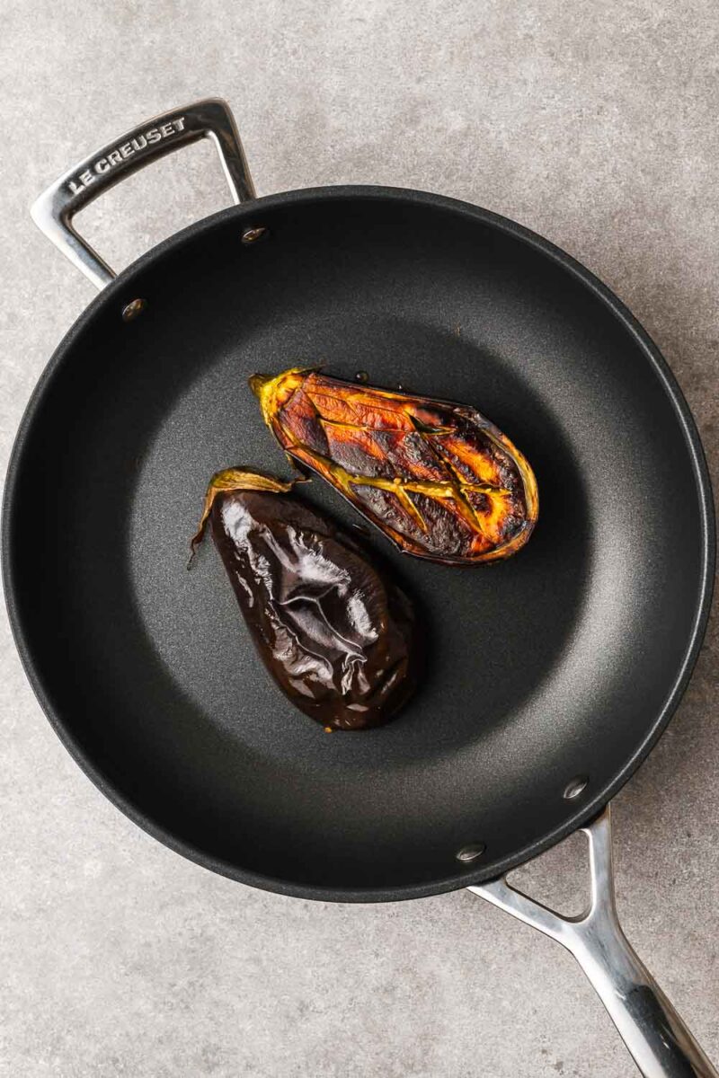 Eggplant cooked on the stovetop in a non-stick frying pan.