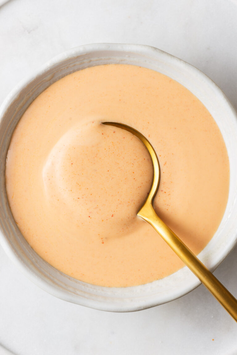 Japanese white sauce (yum yum sauce) in a small bowl with a serving spoon.