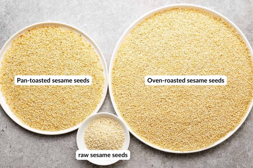 Comparison of a small plate with slightly uneven toasted pan-toasted sesame seeds and evenly oven-roasted sesame seeds.