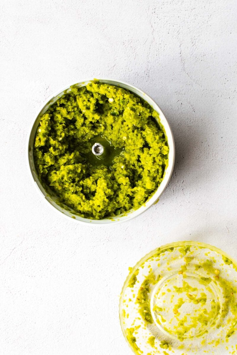 Chopped fermented chilli paste in the bowl of a small food processor.