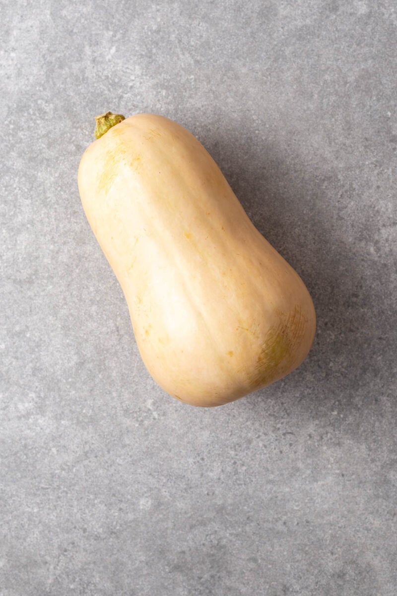 A whole unpeeled butternut squash.